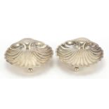 Harrison Brothers & Howson, pair of George V silver shell shaped dishes raised on three ball feet,