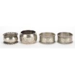 Four Victorian and later silver napkin rings including a pair by Thomas Hayes, Birmingham 1905,