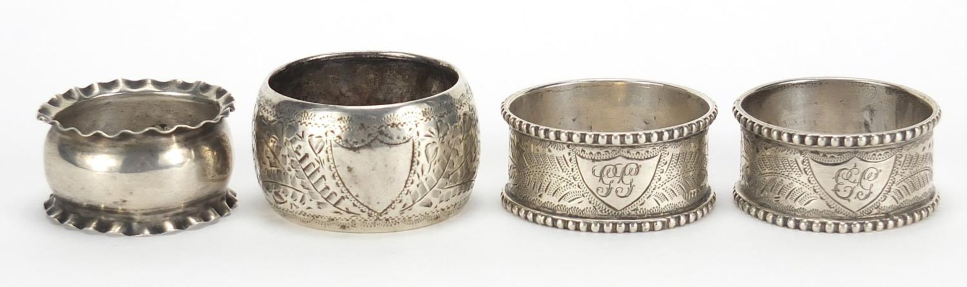 Four Victorian and later silver napkin rings including a pair by Thomas Hayes, Birmingham 1905,