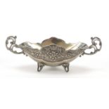 Heavy silver plated twin handled bowl cast with flowers and raised on three feet, 24cm wide :For