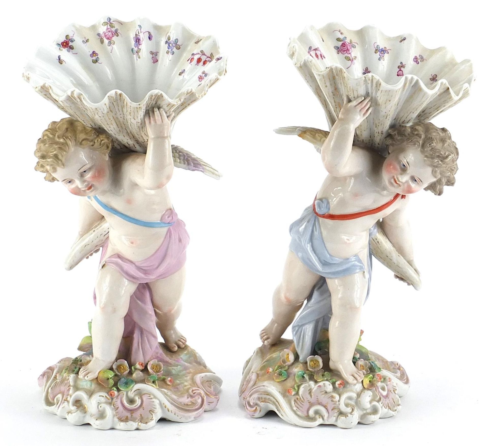 Pair of Continental porcelain Putti and cornucopia design spill vases with floral encrusted bases,