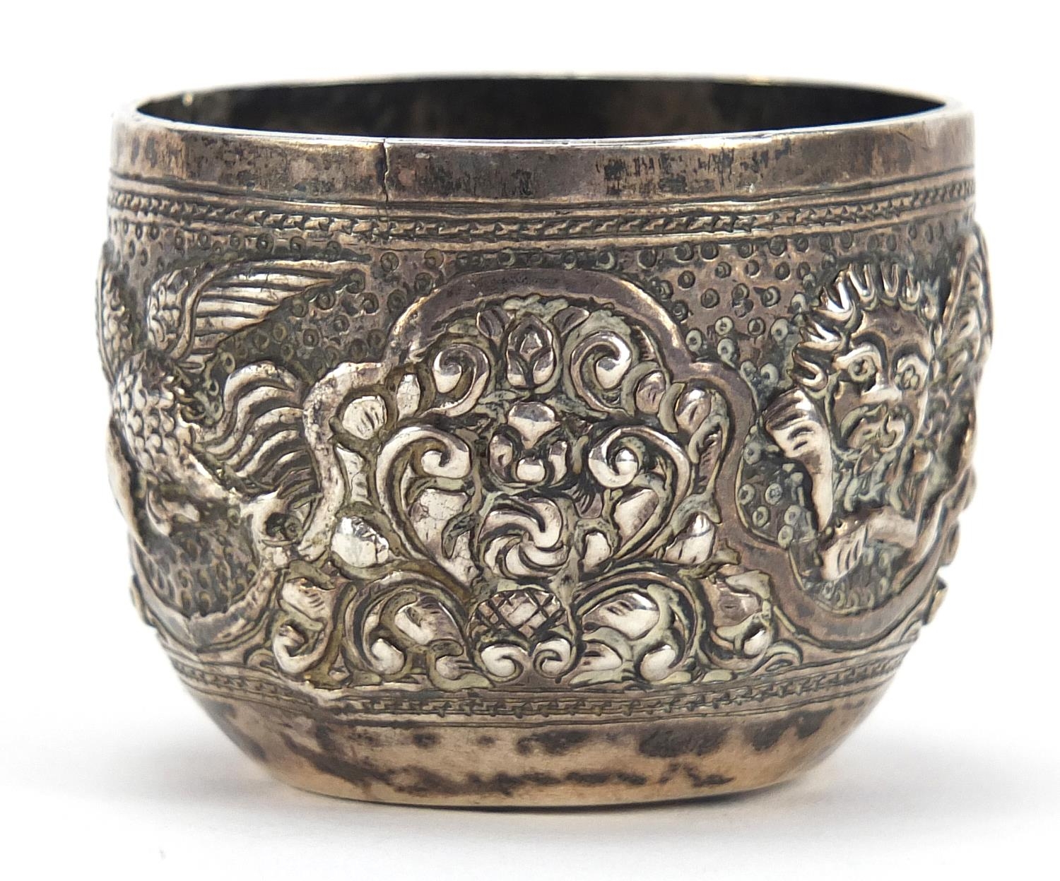 Tibetan silver cup profusely embossed with birds and wild animals amongst foliage, 3.5cm high, 44.4g - Image 2 of 3
