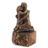 Modernist sculpture of two lovers raised on a naturalistic wood block base, 35cm high :For Further
