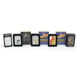 Five Zippo lighters with cases comprising two The Beatles' Yellow Submarine, Rolling Stones, Forty