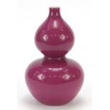 Chinese porcelain double gourd vase having a pink glaze, six figure character marks to the base,