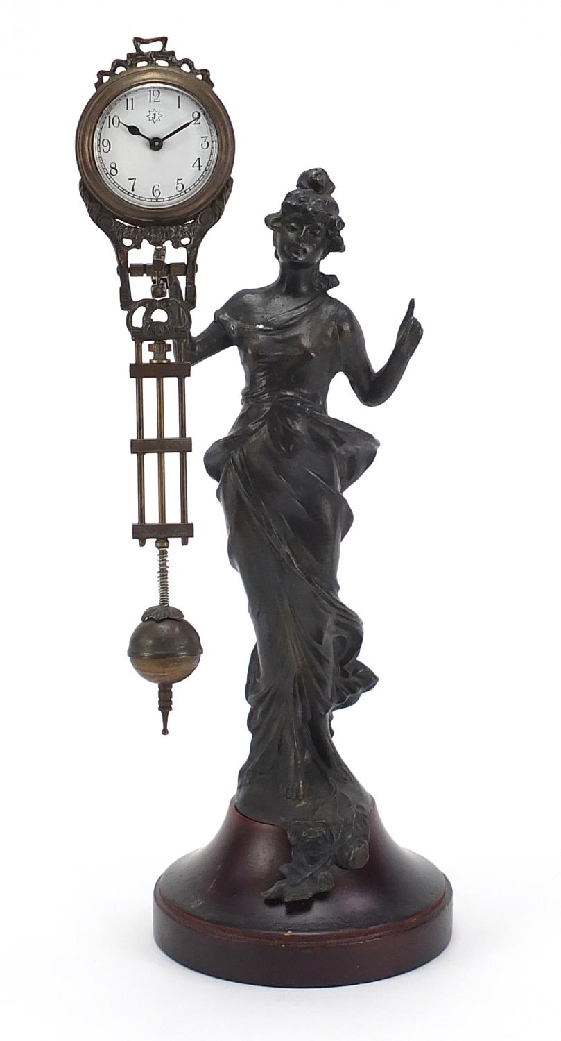 Bronzed mystery clock in the form of an Art Nouveau female, with enamelled dial and Arabic numerals,