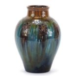 Christopher Dresser for Linthorpe Pottery, Arts & Crafts vase having a mottled glaze incised with