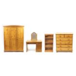 Pine bedroom suite comprising a triple wardrobe, five drawer chest, four shelf open bookcase with