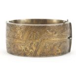 Large Victorian design silver hinged bangle with engraved decoration, Birmingham 1961, 3cm high,