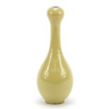 Chinese porcelain garlic head vase having a yellow monochrome glaze, blue ring marks to the base,