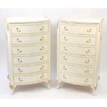 Pair of French style cream and gilt bow fronted six drawer chests, each 125cm H x 70cm W x 47.5cm