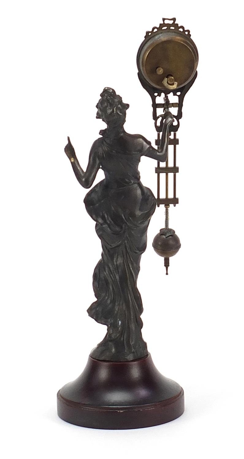 Bronzed mystery clock in the form of an Art Nouveau female, with enamelled dial and Arabic numerals, - Image 3 of 4