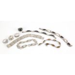 Five silver bracelets and four silver rings, some set with semi precious stones, total 102.5g :For