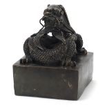 Large Chinese patinated bronze dragon seal, character marks to the base, 15cm high :For Further