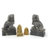 Chinese stone carvings including a pair of Foo dogs and a Buddha, the largest each 18cm high :For