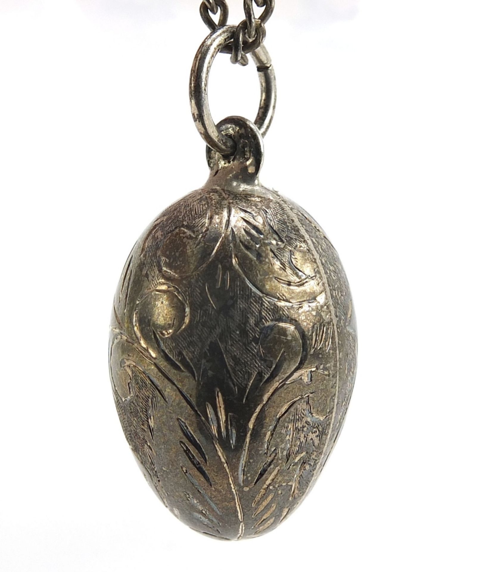 Silver engraved egg pendant on a sterling silver necklace, 4cm high and 56cm in length, total 19.