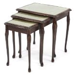 Nest of three mahogany occasional tables with tooled leather inserts and glass tops, the largest