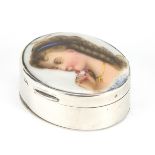 Edwardian oval silver snuff box, the hinged lid enamelled with a young female smelling flowers, J.