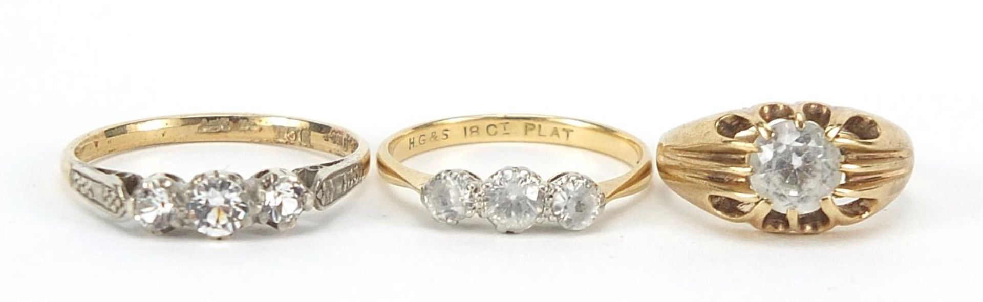 Three 18ct gold and 9ct gold clear stone rings, sizes F, L and O, 6.0g : For Further Condition
