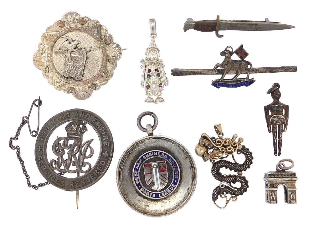 Brooches, badges and charms, some silver including The Queen's Regiment, Bayonet brooch, Victorian
