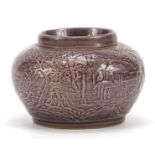 Chinese porcelain vase having a purple glaze decorated in low relief with a continuous landscape,