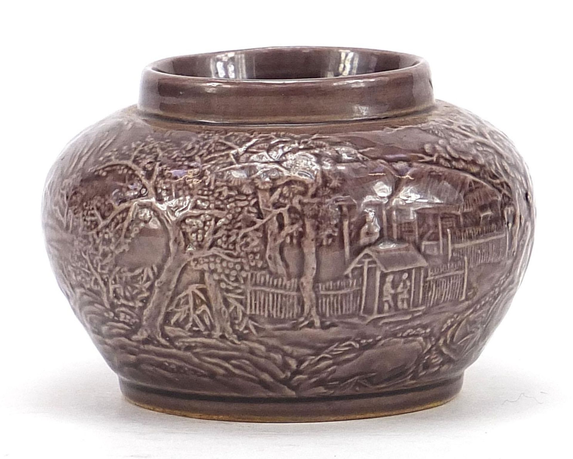Chinese porcelain vase having a purple glaze decorated in low relief with a continuous landscape,