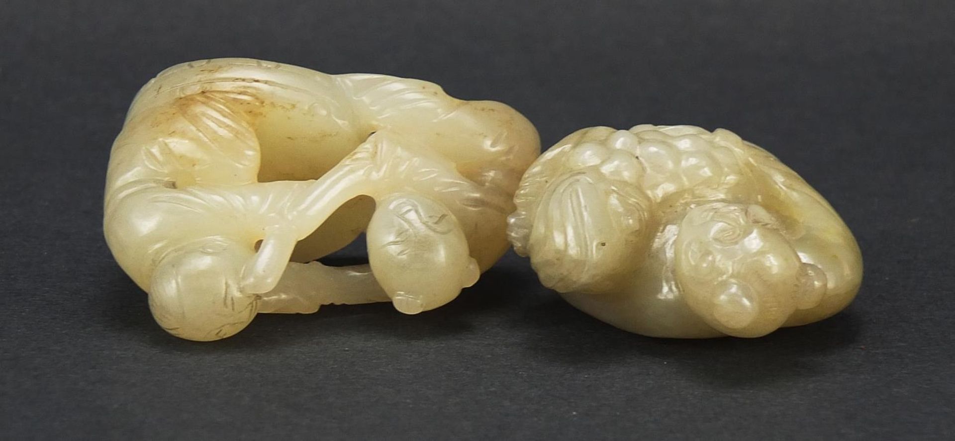 Two Chinese celadon and russet jade carvings including one of a figure holding fruit, the largest - Image 6 of 7