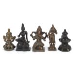 Four Indian patinated bronze votive figures and a bird weight, the largest 6.5cm high : For