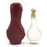 Antique cut glass scent bottle with Chelsea style porcelain bird stopper and gilt metal mounts,