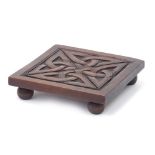 Celtic carved hardwood teapot stand, 18cm x 18cm : For Further Condition Reports Please Visit Our