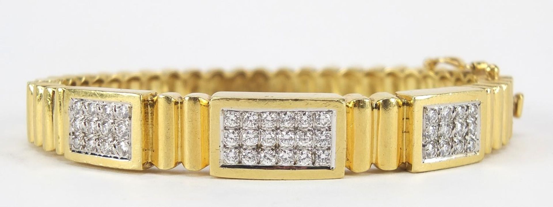 18ct gold diamond cluster hinged bangle, set with forty two diamonds the diamonds approximately 2.