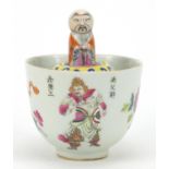 Unusual Chinese porcelain bowl with attached water pot containing a robed figure that rises out of