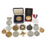 Commemorative medallions and medals including a silver example presented by Ryder & Son, Woman's Own