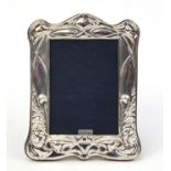 Art Nouveau design silver easel photo frame embossed with stylised flowers, London 2018, 20cm high :