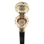 Hardwood walking stick with carved bone globe design handle opening to reveal a compass, 84cm in