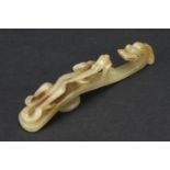 Chinese celadon jade belt hook carved with dragons, 9cm in length : For Further Condition Reports