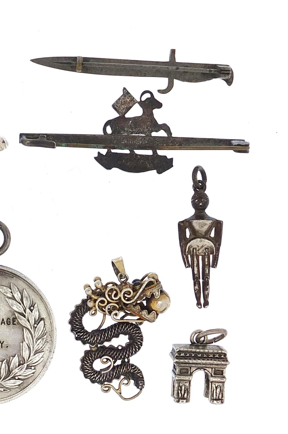 Brooches, badges and charms, some silver including The Queen's Regiment, Bayonet brooch, Victorian - Image 3 of 6