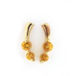 Pair of 9ct gold citrine stud earrings, housed in a leather lined turned wooden box, the earrings
