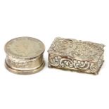 Two silver pill boxes comprising one embossed with Putti by Joseph Gloster Ltd 1969 and a half crown