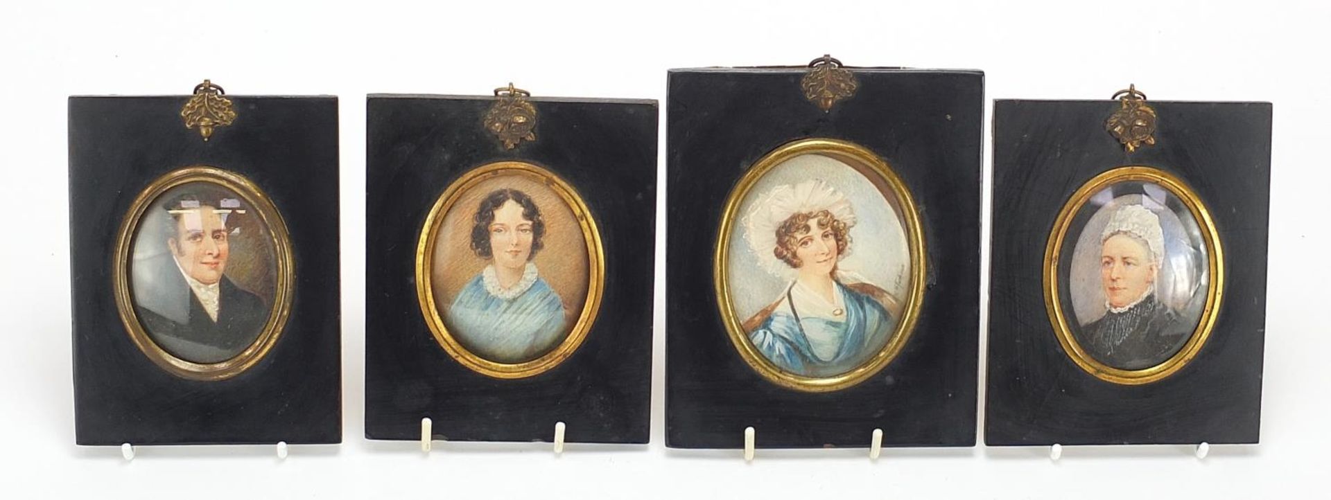 Four Victorian oval hand painted portrait miniatures, including one of a lady wearing a bonnet,