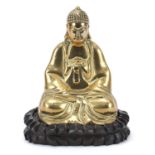 Chinese bronzed figure of Buddha raised on a carved hardwood lotus stand, 23.5cm high : For