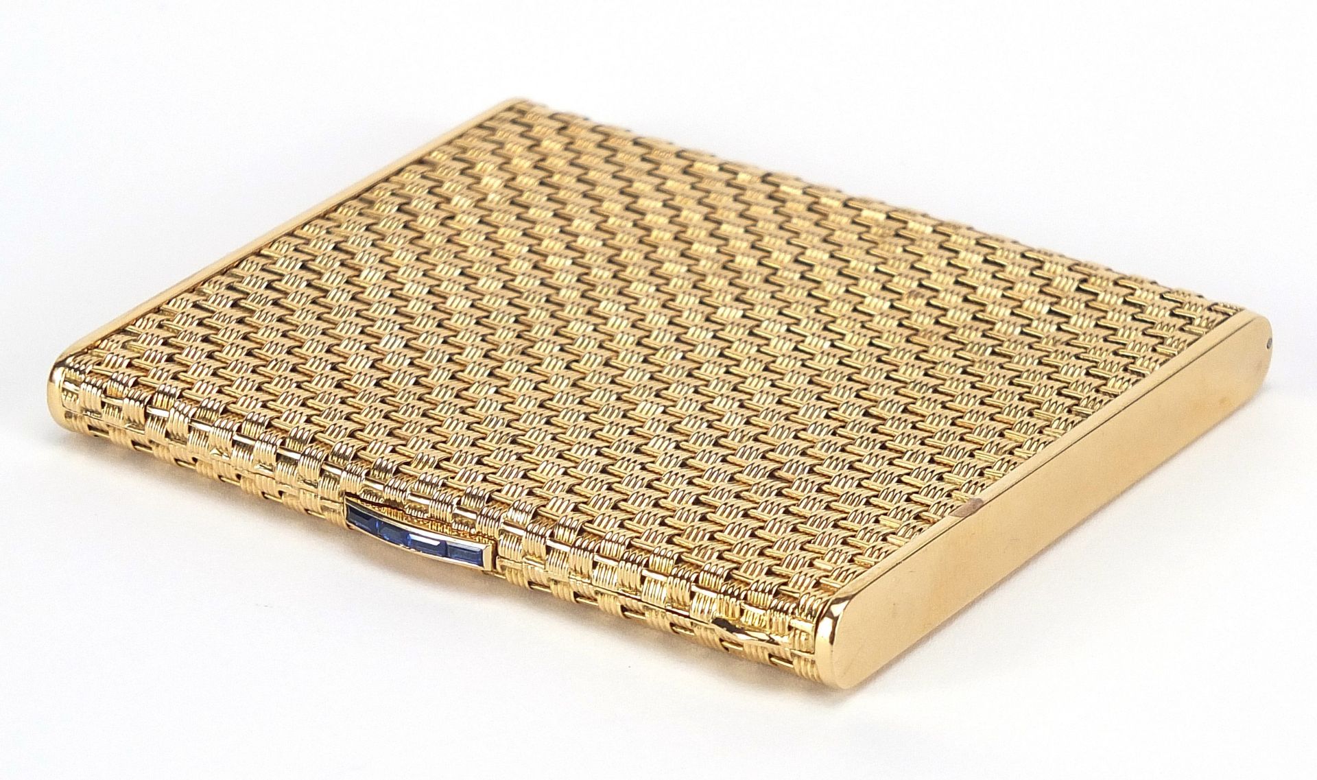 18ct gold basket weave design cigarette case with blue sapphire push button, marked 750 to the