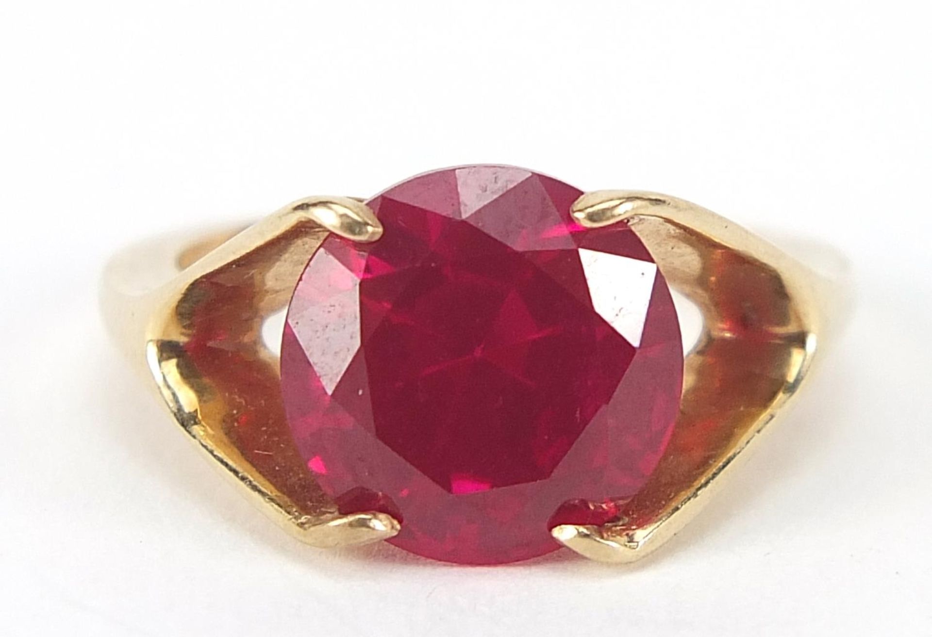 Unmarked gold ruby solitaire ring, the stone approximately 10mm in diameter, size J, 3.6g : For