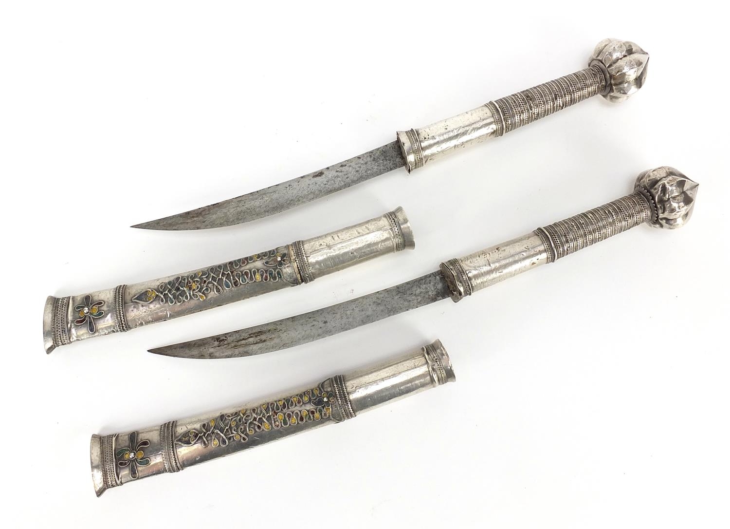 Pair of Middle Easter silver mounted daggers with enamelled scabbards, possibly Sumatran, both