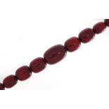 Very large cherry amber coloured bead necklace, the largest bead 4cm in length, 52cm in length,