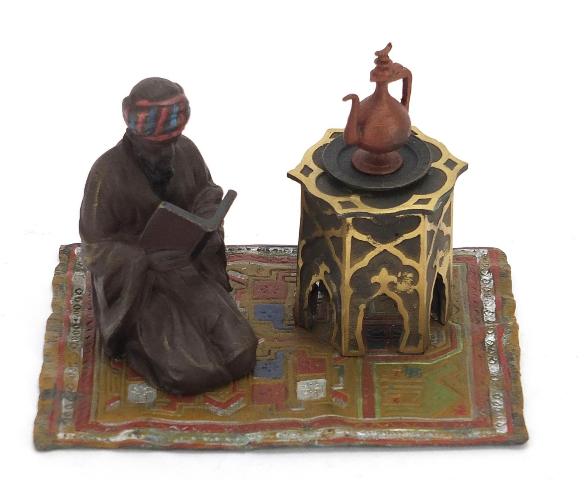 Cold painted bronze figure of an Arab on a carpet in the style of Franz Xaver Bergmann, 14cm