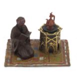 Cold painted bronze figure of an Arab on a carpet in the style of Franz Xaver Bergmann, 14cm