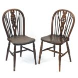 Two oak wheel back dining chairs, each 90cm high : For Further Condition Reports Please Visit Our