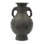 Large Chinese patinated bronze archaic vase with twin handles and mythical faces, character marks to
