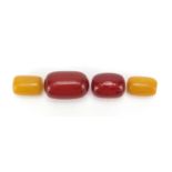 Four amber coloured beads, the largest 33mm wide, total 28.6g : For Further Condition Reports Please